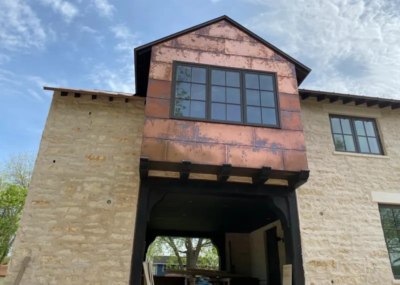 Copper metal panel facade on a stone building for Metal Roof Coating in Eagle Point